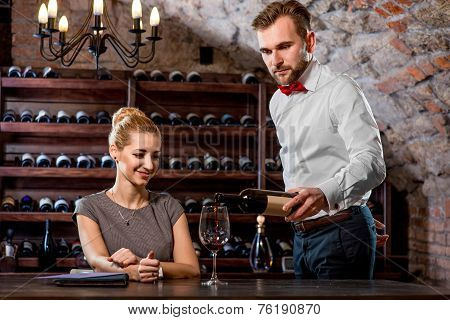 Sommelier with young woman on degustation in the cellar