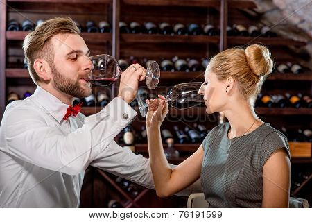 Couple having romantic wine tasting at the cellar