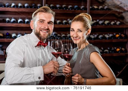 Couple having romantic wine tasting at the cellar