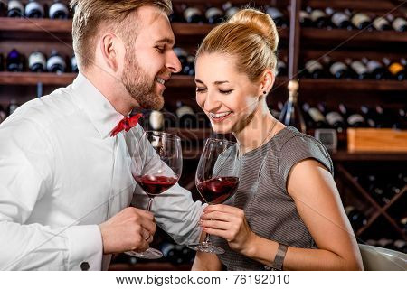 Couple having romantic wine tasting at the cellar