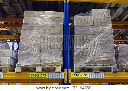 Pallets With Boxes Stand On A Shelf Goods Warehouse.