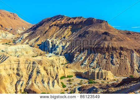  Picturesque multicolored sandstone dry talus. Ancient mountains in the valley of the Dead Sea