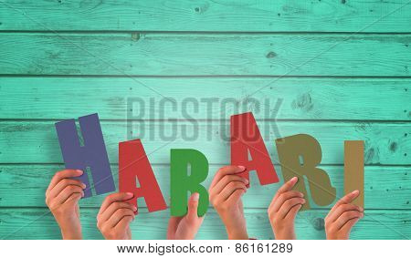 Hands holding up habari against digitally generated grey wooden planks