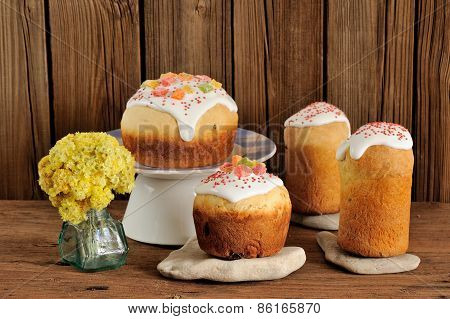 Paska, East European Easter Sweet Breads Decorated With Icing And Candied Fruits With Yellow Flowers