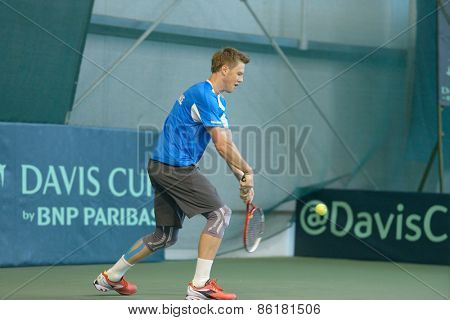 DNEPROPETROVSK, UKRAINE - APRIL 4, 2013: Illya Marchenko, Ukraine on the training before Davis Cup match Ukraine vs Sweden. Ukraine won the match 3-2