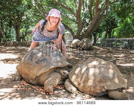 Woman and big turtles