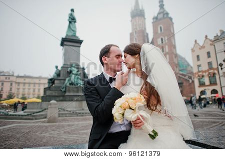 Young Elegant And Hearty Wedding Couple In Love On Streets Of Krakow, Poland