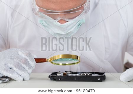 Man With Harddisk And Magnifying Glass