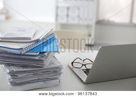 office desk a stack of computer paper reports work forms
