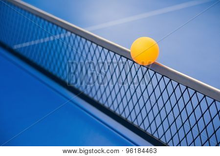 Yellow Ball Hits The Racket On A Blue Pingpong Table