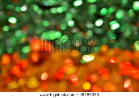 Bright and abstract blurred green and golden background with shimmering glitter