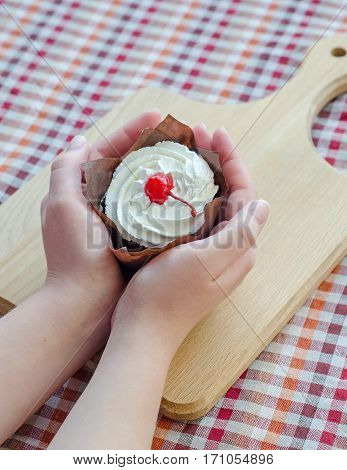 In female hands cottage cheese cake with cherries and cream