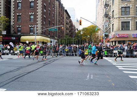 Marathoners and spectators at 16th mile in the Upper East Side, New York City Marathon - November 6, 2016, First avenue and 65th, New York City, NY, US