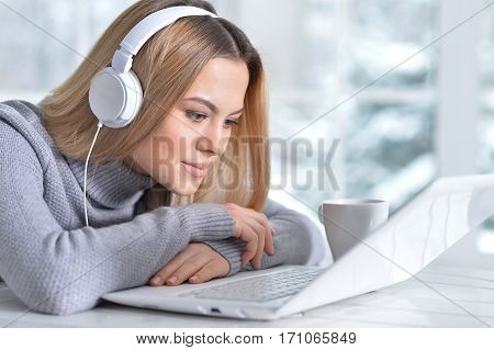Portrait of a young beautiful blonde woman using laptop
