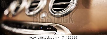Luxury car dashboard with selective focus on air deflector