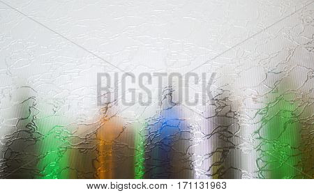 Blurred defocused bottles abstract background. Colorful bottles.