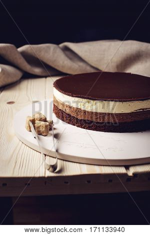 Delicious Three-layer Chocolate Cake Stands On A Circular Base