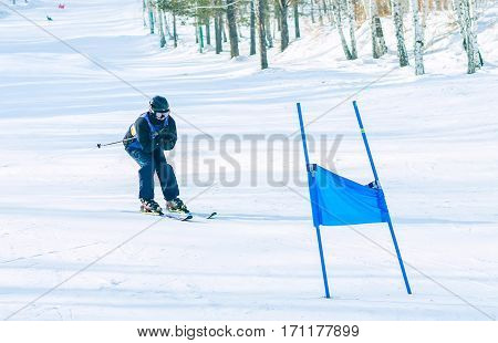 Irkutsk, Russia - February 12, 2017: Slalom competition snowboarding and skiing for adults and children in Irkutsk on the ski base in Akademgorodok Academy Cup in 2017