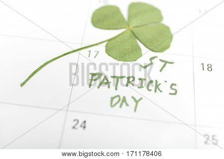 st patricks day on march calendar pin and clover..