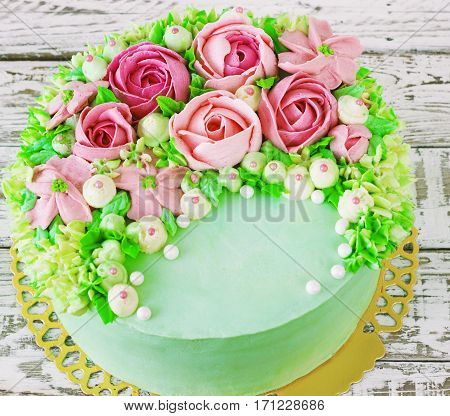Birthday cake with flowers rose on white background toning