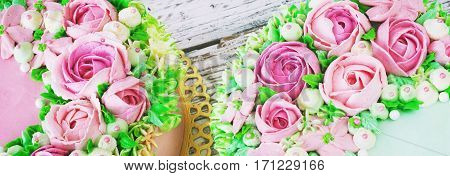 Two celebratory cake with flowers rose on a white wooden background.