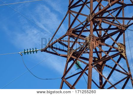 Supports High-voltage Power Lines Against The Blue Sky With Clouds. Electrical Industry