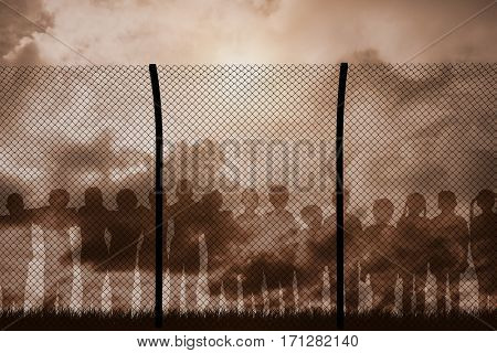 Digital composite image of fence against blue sky with white clouds