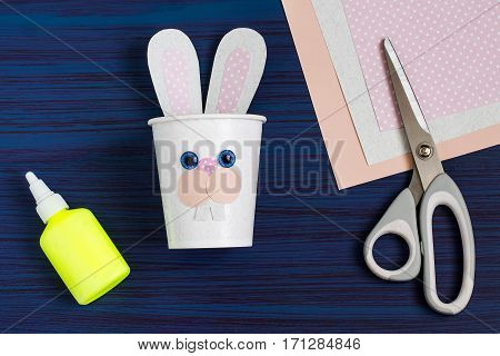 Homemade making of boxes from paper cups for sweets and candy in form of Easter hare. Present children. DIY concept. Step by step photo instructions. Step 5. Gluing nose hare
