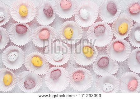 Colorful pastel Easter eggs mini chocolate candy eggs traditional Easter treats Easter eggs background top view