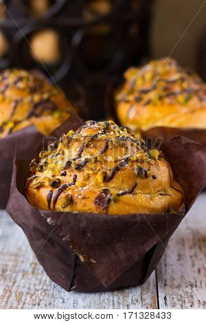 Muffins with chocolate and pistachios in kraft paper