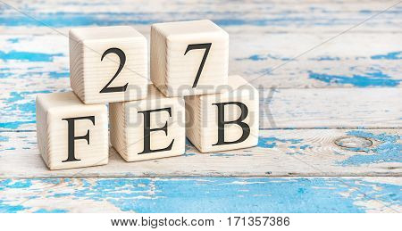 February 27Th. Wooden Cubes With Date Of 27 February On Old Blue Wooden Background.