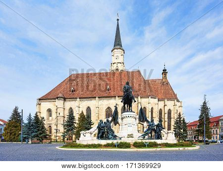Unirii square and the medieval gothic st michael church in cluj napoca romania, statue of matei corvin