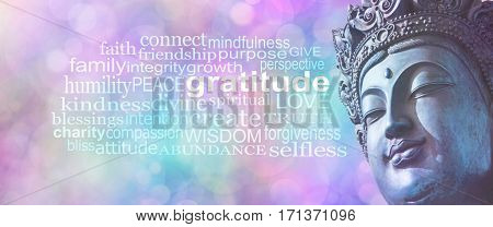 Gratitude Buddhism Word Cloud Banner - Close up of blue grunge style Buddha head on wide pink blue bokeh background with a GRATITUDE word cloud on left side