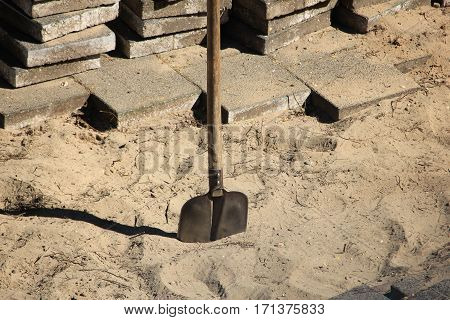 Pavior at work: stacked tiles for a pavement job