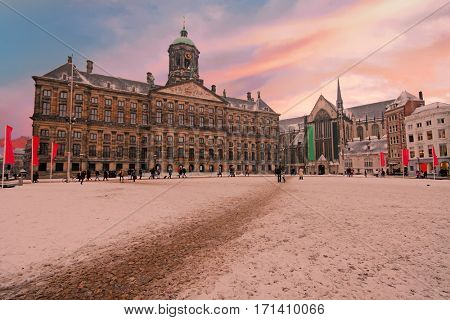 Snowy Dam square in Amsterdam the Netherlands in winter at sunset