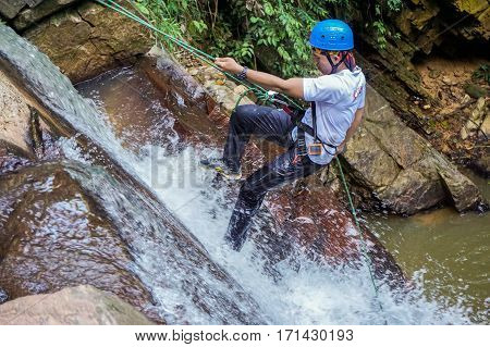 Beaufort,Sabah,Malaysia-Jan 28,2017:Adventure man rappelling Jempangah waterfall in Beaufort,Sabah,Borneo.Waterfall Abseiling activity adventure getting famous in Sabah,Borneo,Malaysia