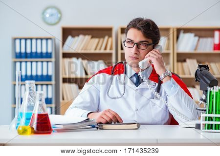 Superhero doctor working in the hospital lab
