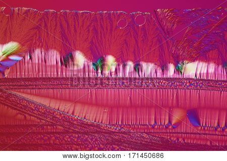 Colorful micro crystals through the microscope in polarized light