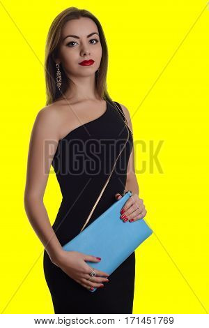 Fashionable Woman With A Dlue Bag In Her Hands And Black Evening Dress