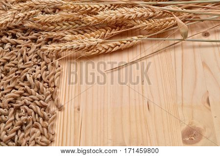 Picture Of Wholemeal Pasta From Organic Grain And Ears Of Wheat On A Rustic Wooden Table. Raw Materi