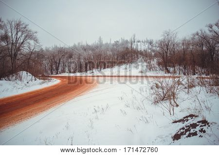 View on winter road that is red because of ore