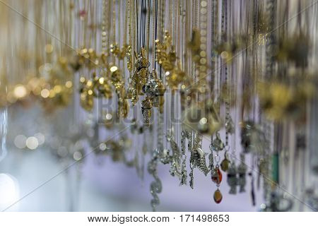 Many crystal pendant necklace hanging in shop