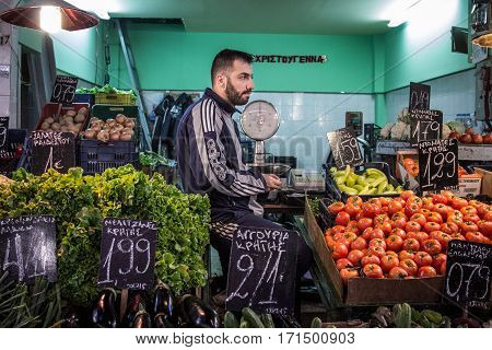 THESSALONIKI GREECE - DECEMBER 24 2015: Fruits and vegetables seller in Modiano market