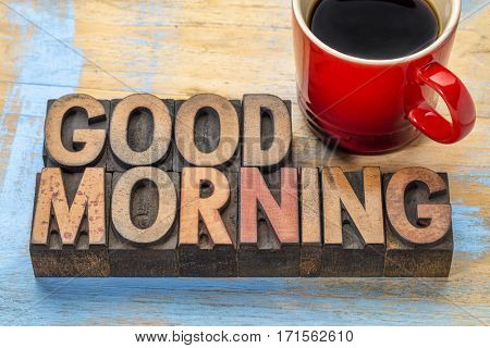 Good morning banner in vintage letterpress wood type blocks with a cup of coffee