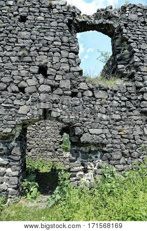 medieval castle wall ruins with door and window holes