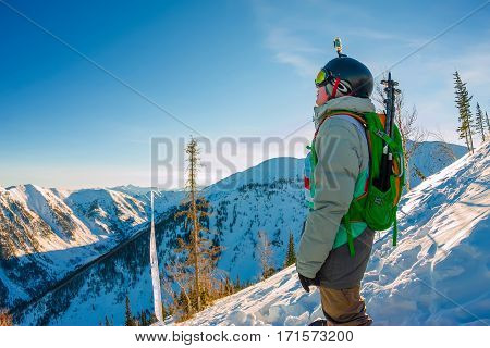 Freeride Snowboarder Stands On Hillside In Light Dawn Sun