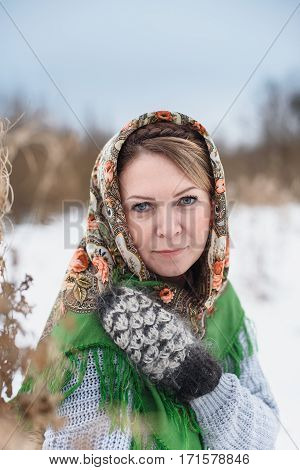 Beautiful Russian woman in a scarf .