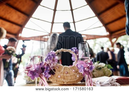 A View On The Wedding Couple Standing In The Restaurant From Behind. Glasses With Champagne Stand On