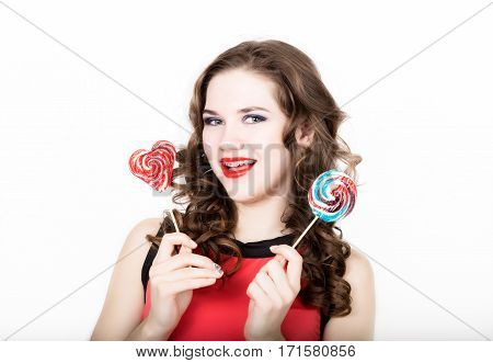 portrait of young beautiful woman with dental braces holding sugarplum.