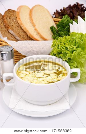 broccoli puree soup with sour cream in a white plate